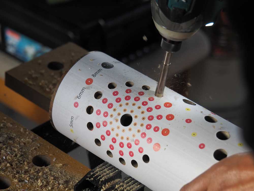 Drilling holes along a paper pattern cut into 30cm pieces.
